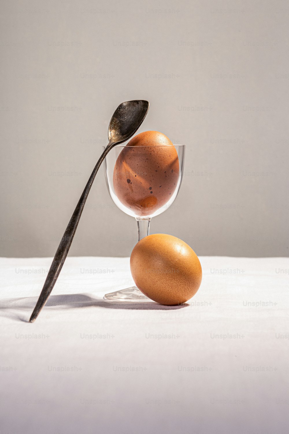 an egg and a spoon on a table