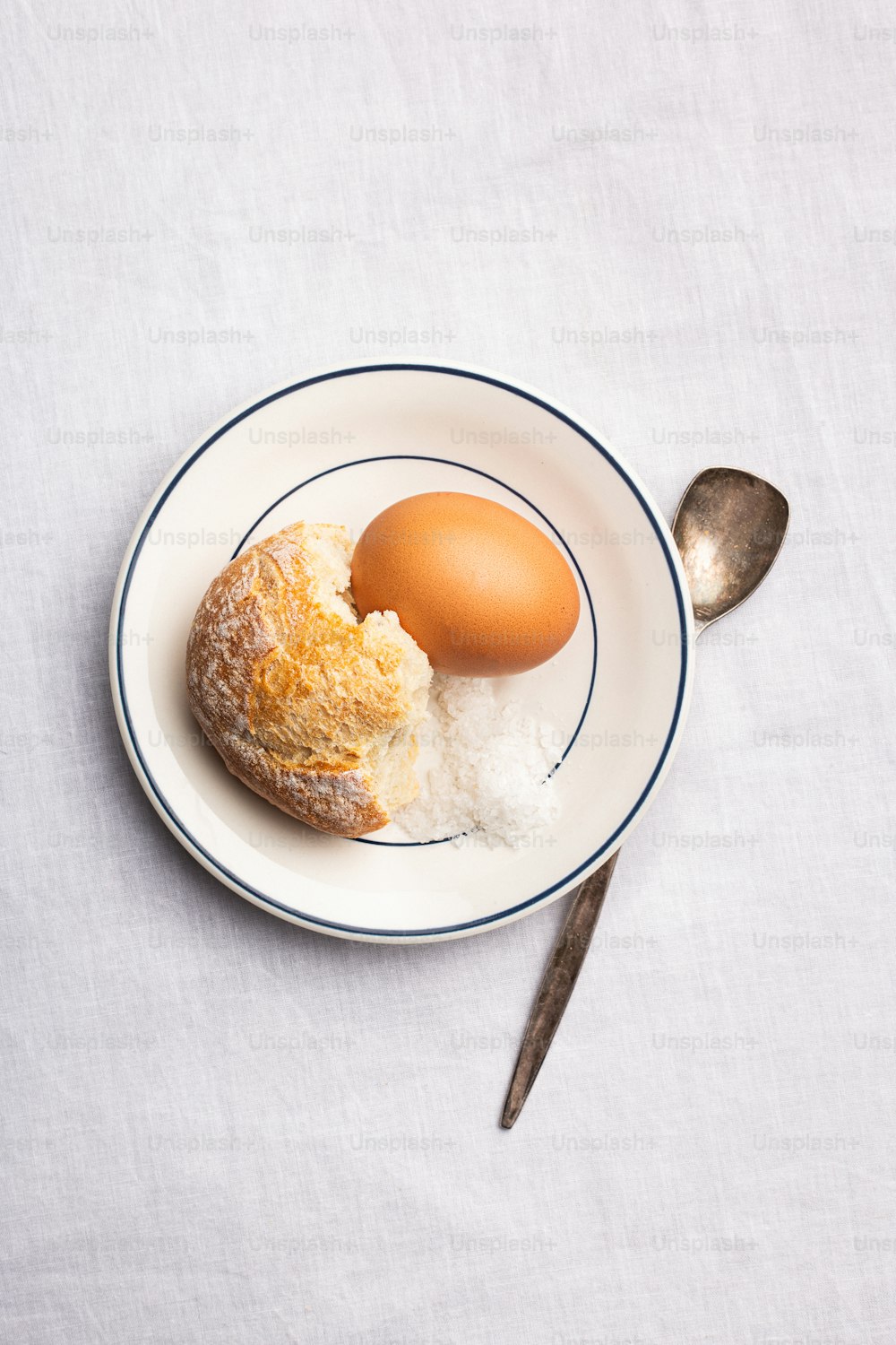 a white plate topped with a piece of bread and an egg