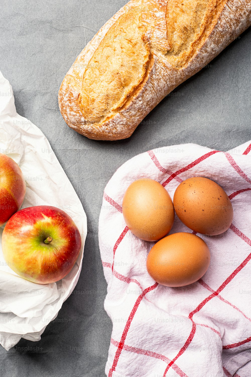 a table topped with bread, eggs and fruit
