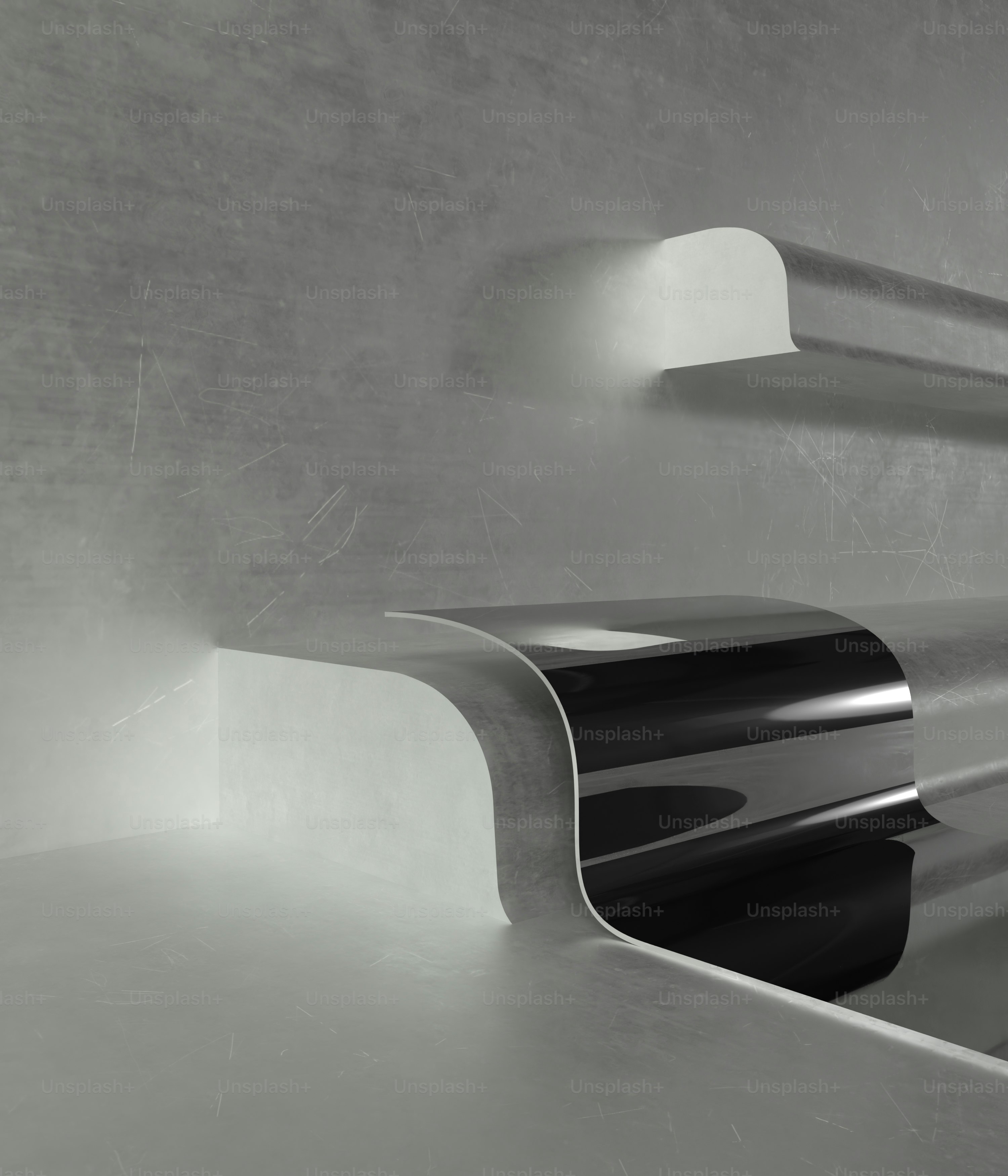 a black and white photo of a curved metal object