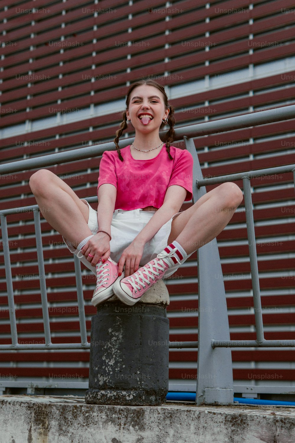 a woman sitting on top of a cement block