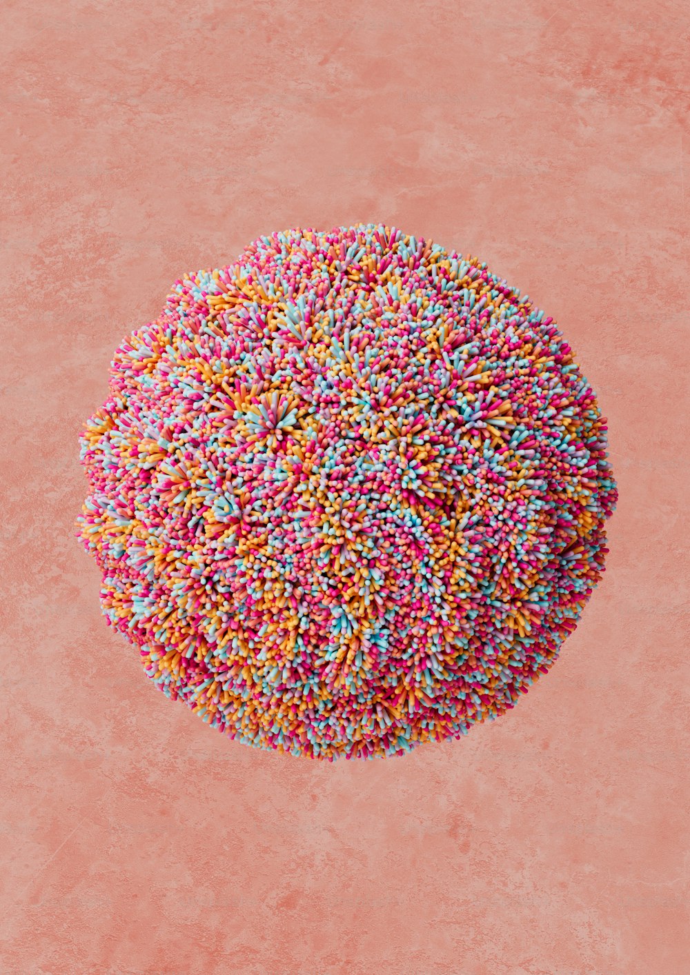 a sprinkled donut on a pink background