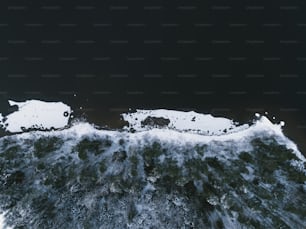 an aerial view of a body of water covered in snow
