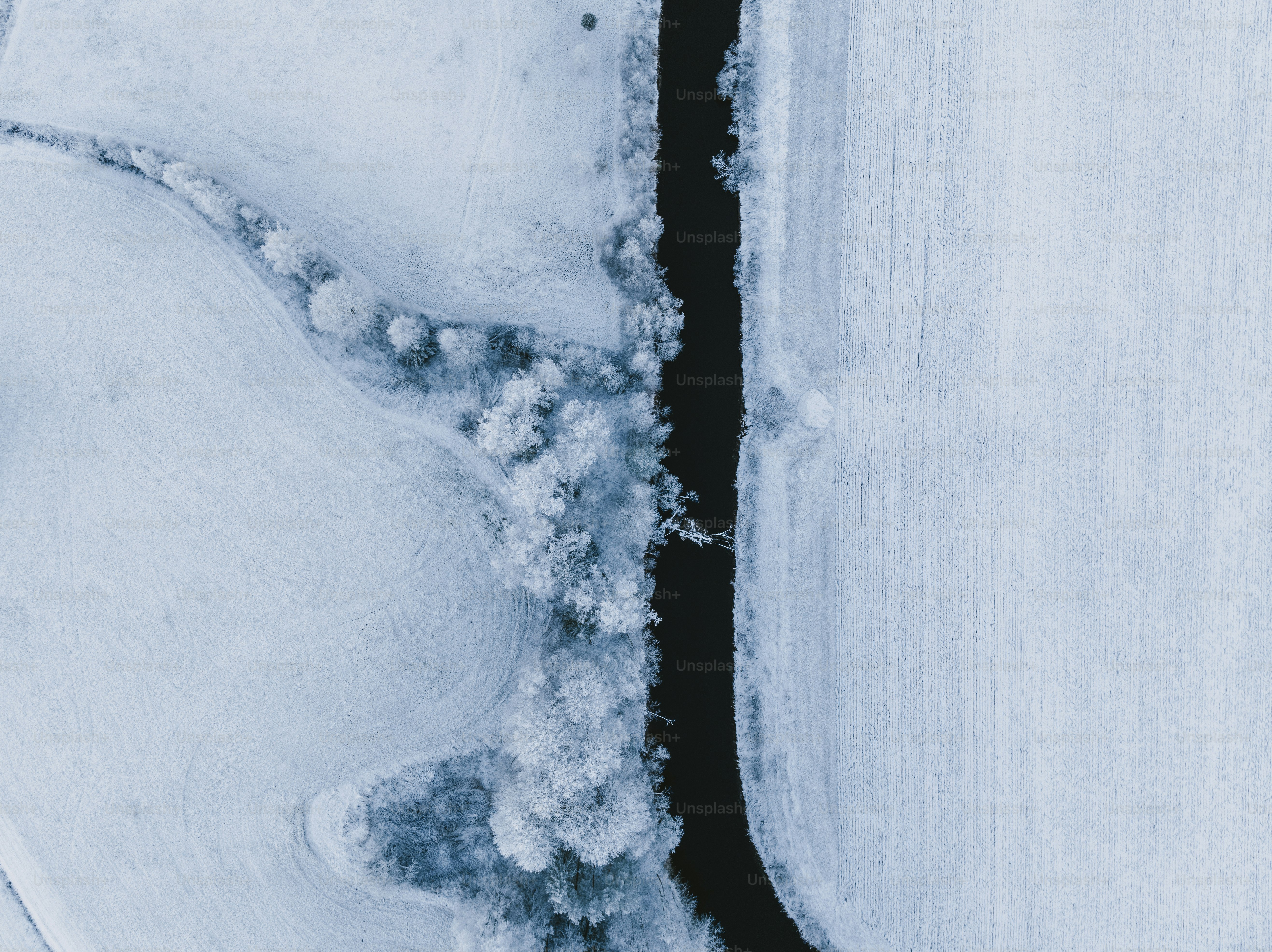 an aerial view of a snow covered field