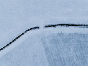 a snowboarder riding down a snow covered slope