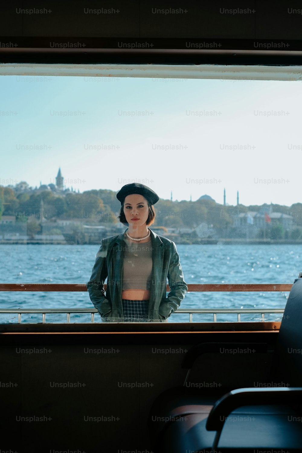 a woman standing on a boat looking out the window