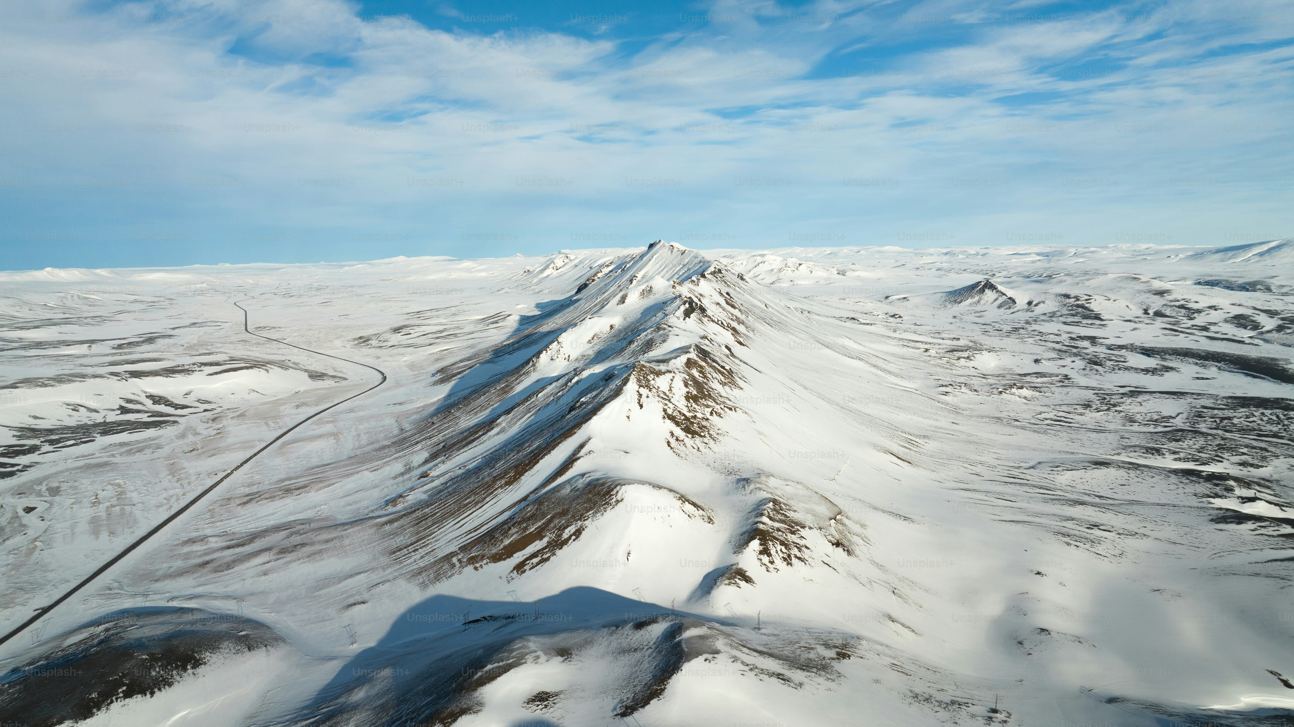 An aerial view of a snow covered landscape photo – Car Image on Unsplash