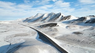 an aerial view of a snow covered mountain range