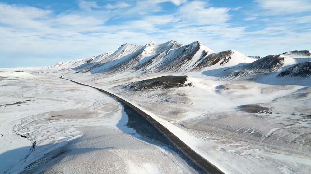 an aerial view of a snow covered mountain range