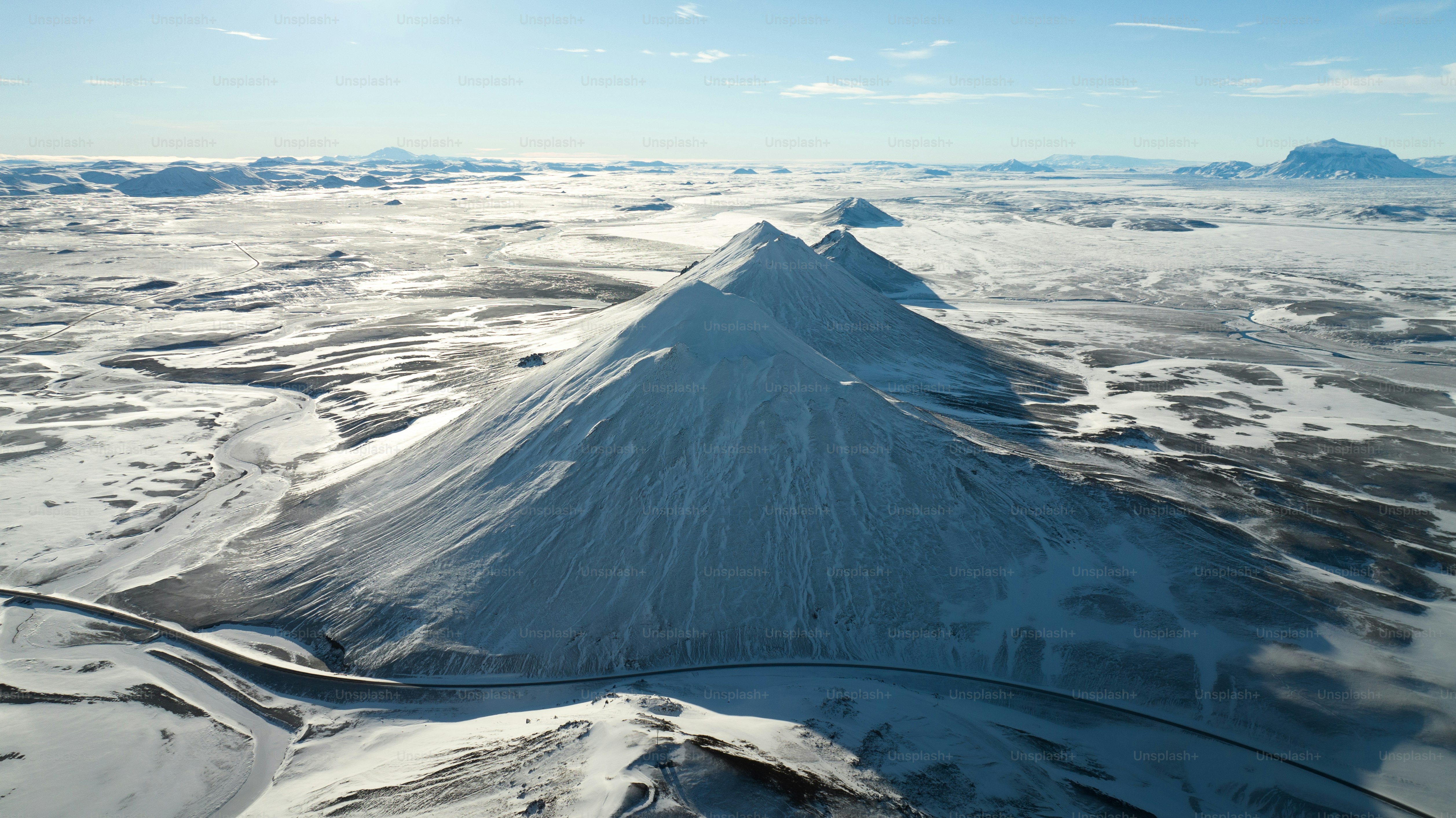 an aerial view of a snow covered mountain