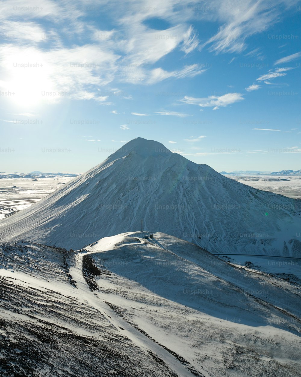 a snow covered mountain under a blue sky