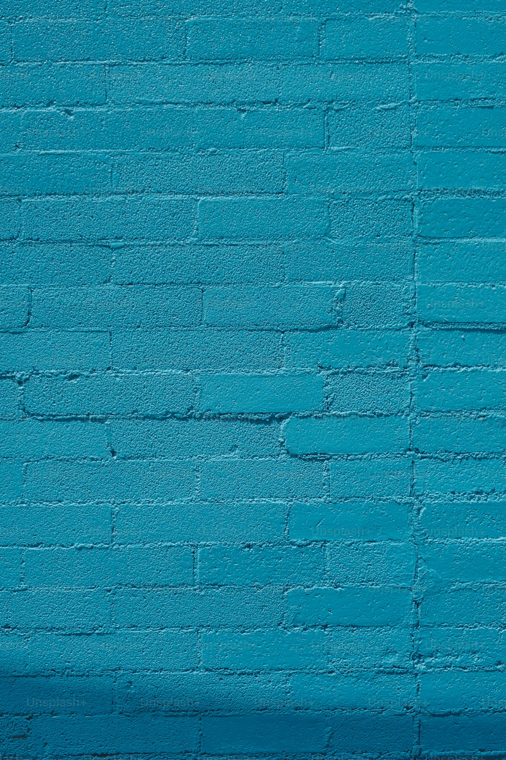 a blue brick wall with a stop sign on it