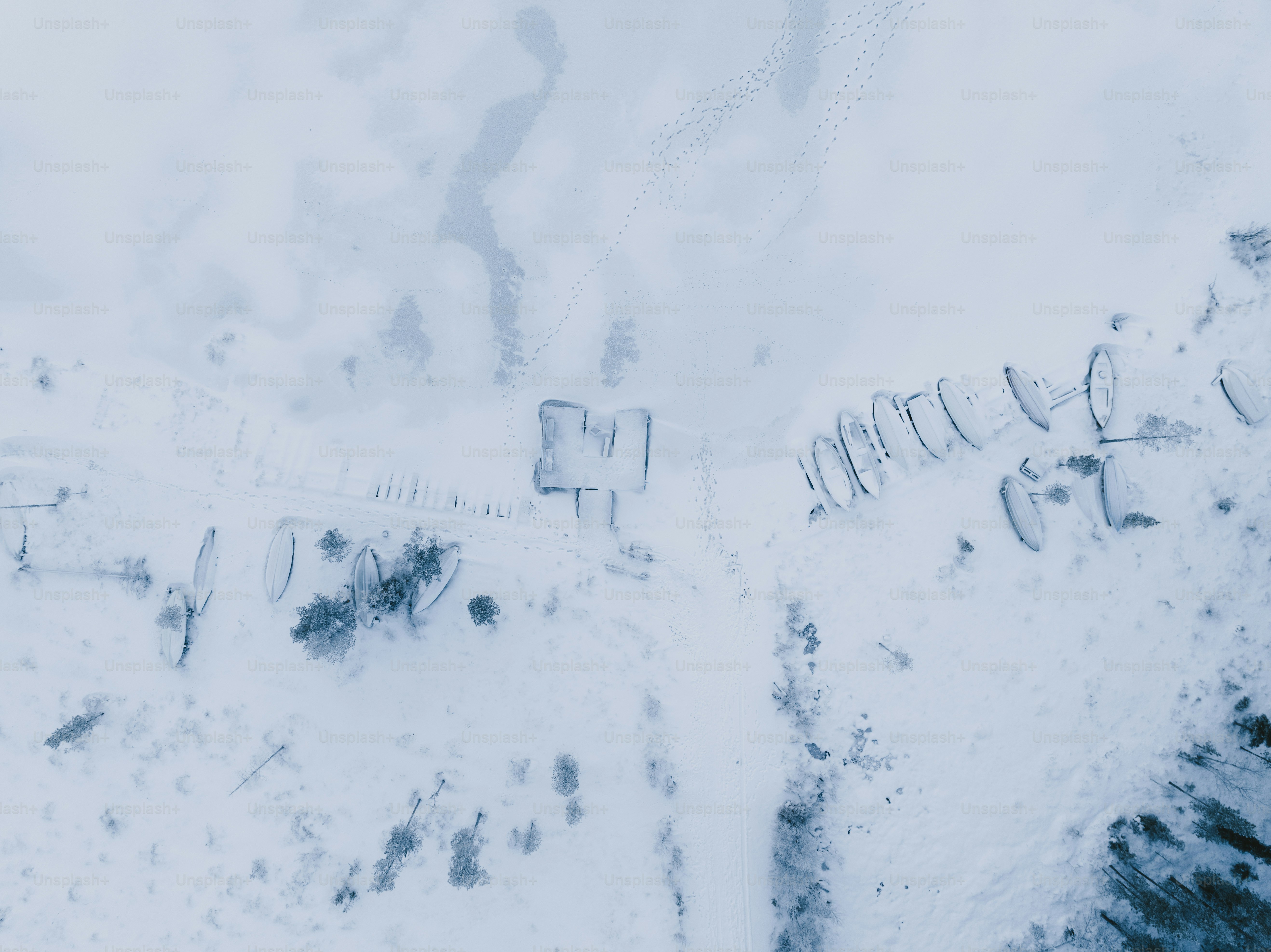 an aerial view of a snow covered field
