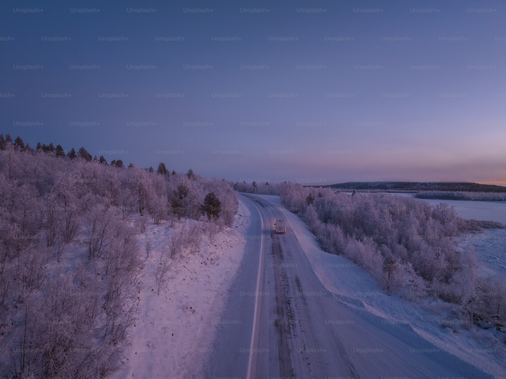 a truck is driving down a snowy road