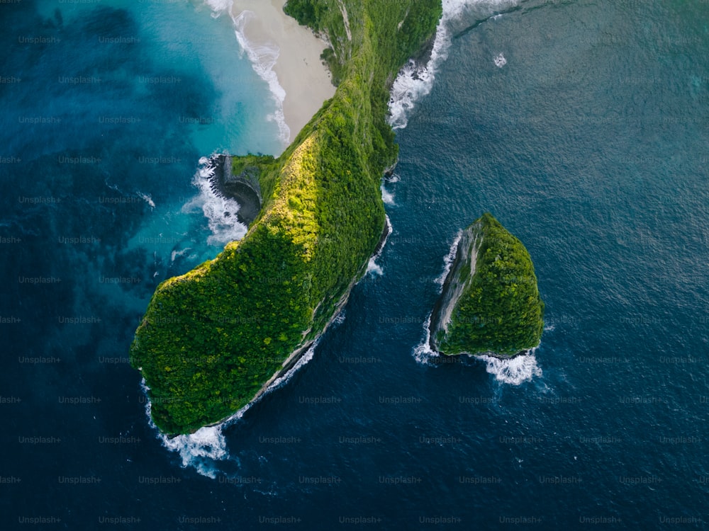 an aerial view of a green island in the ocean