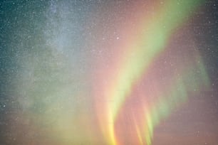 a bright green and yellow aurora bore is in the sky