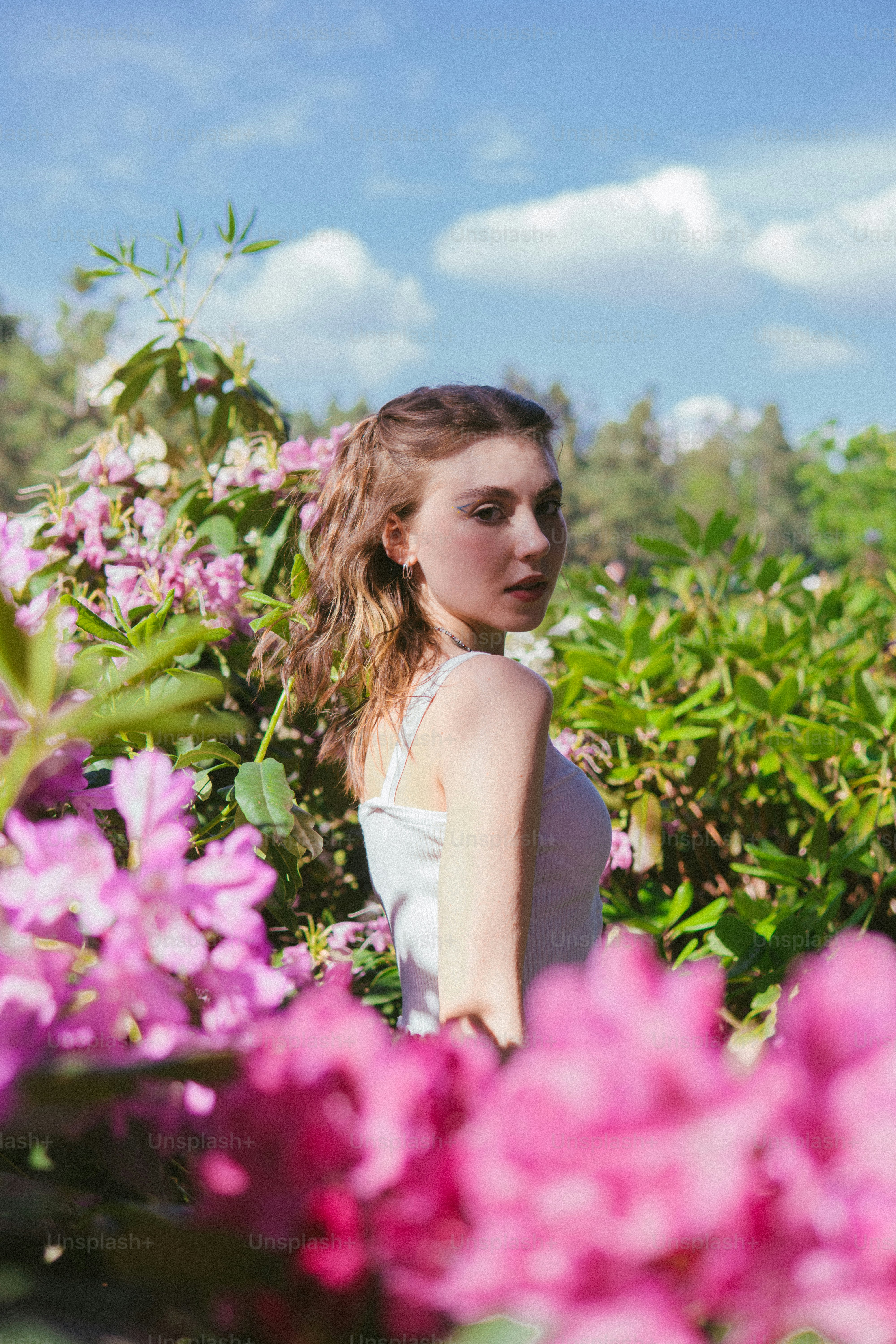 a woman standing in a field of flowers