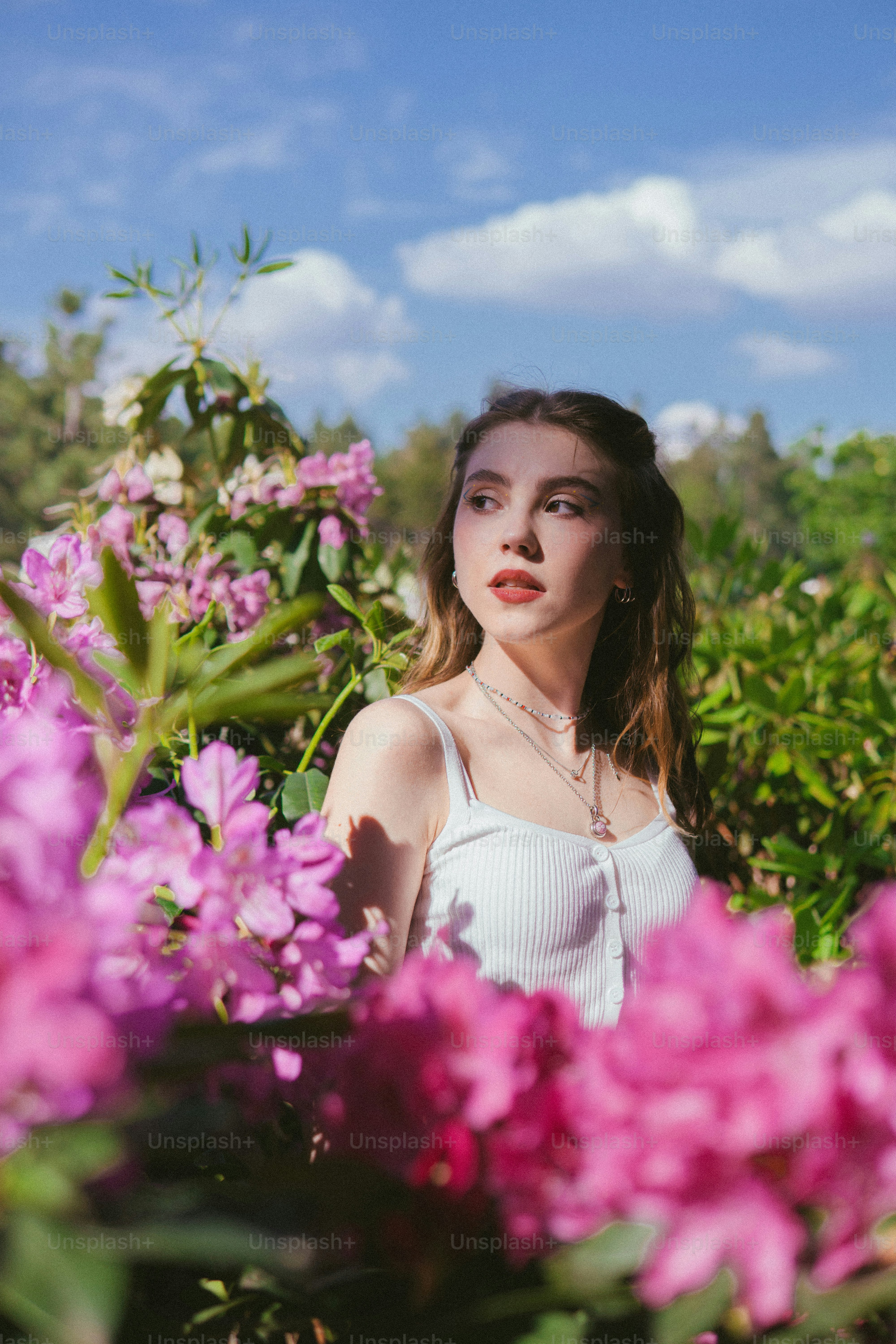 a woman standing in a field of flowers