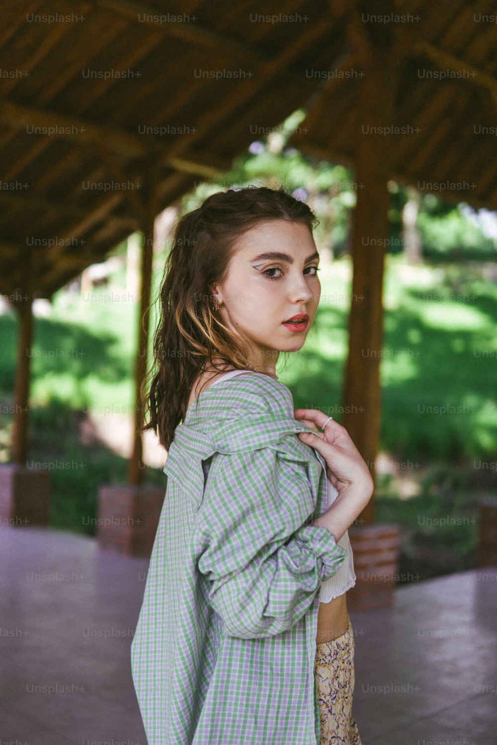 a woman in a green and white checkered shirt