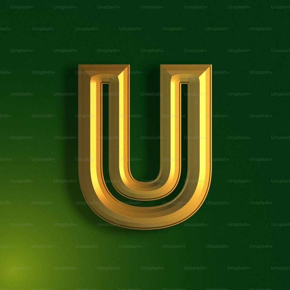 a gold letter u on a green background