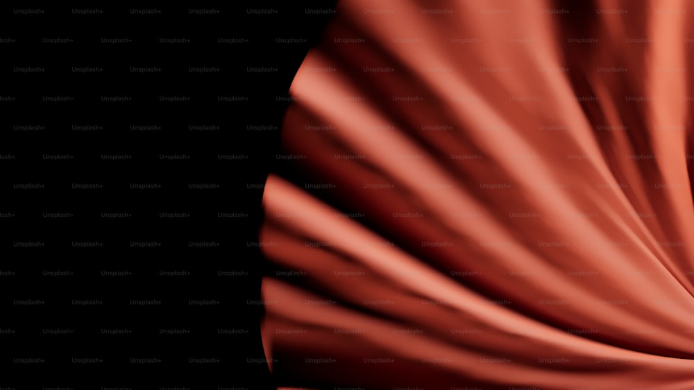 a close up of a red cloth on a black background
