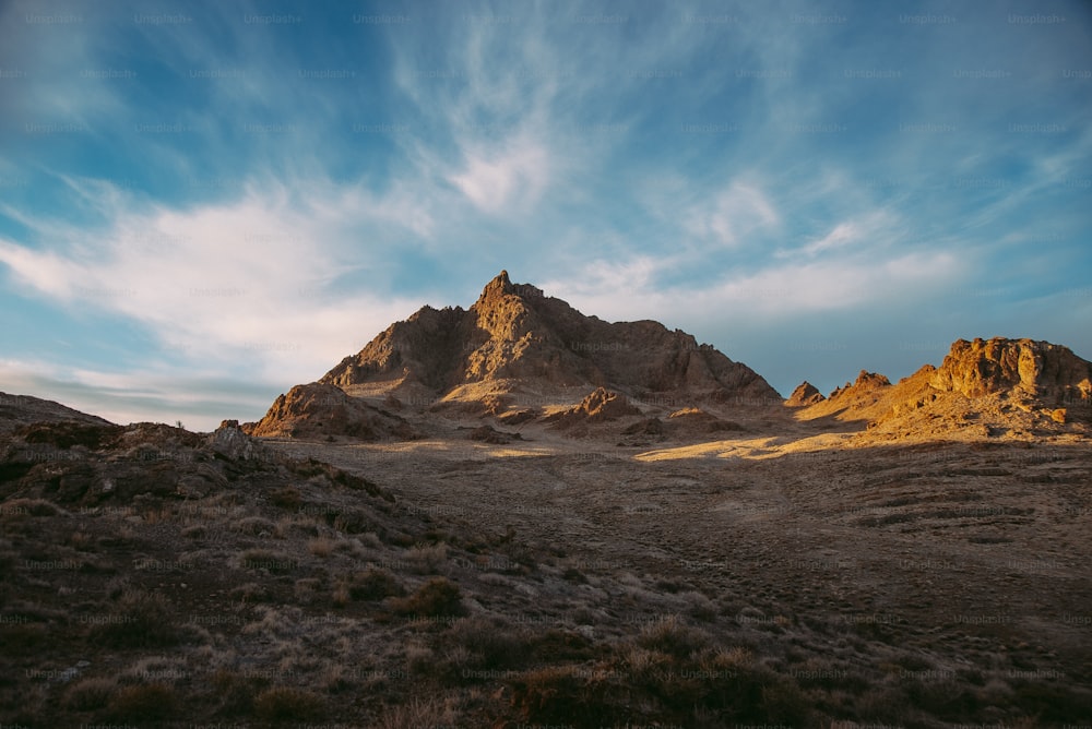 a mountain range with a blue sky in the background