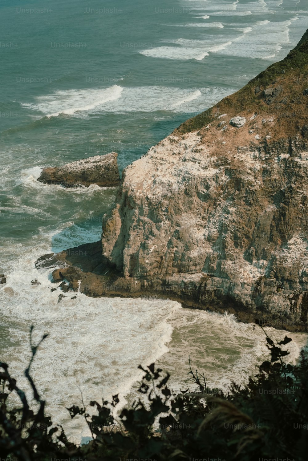 a rocky cliff overlooks a body of water