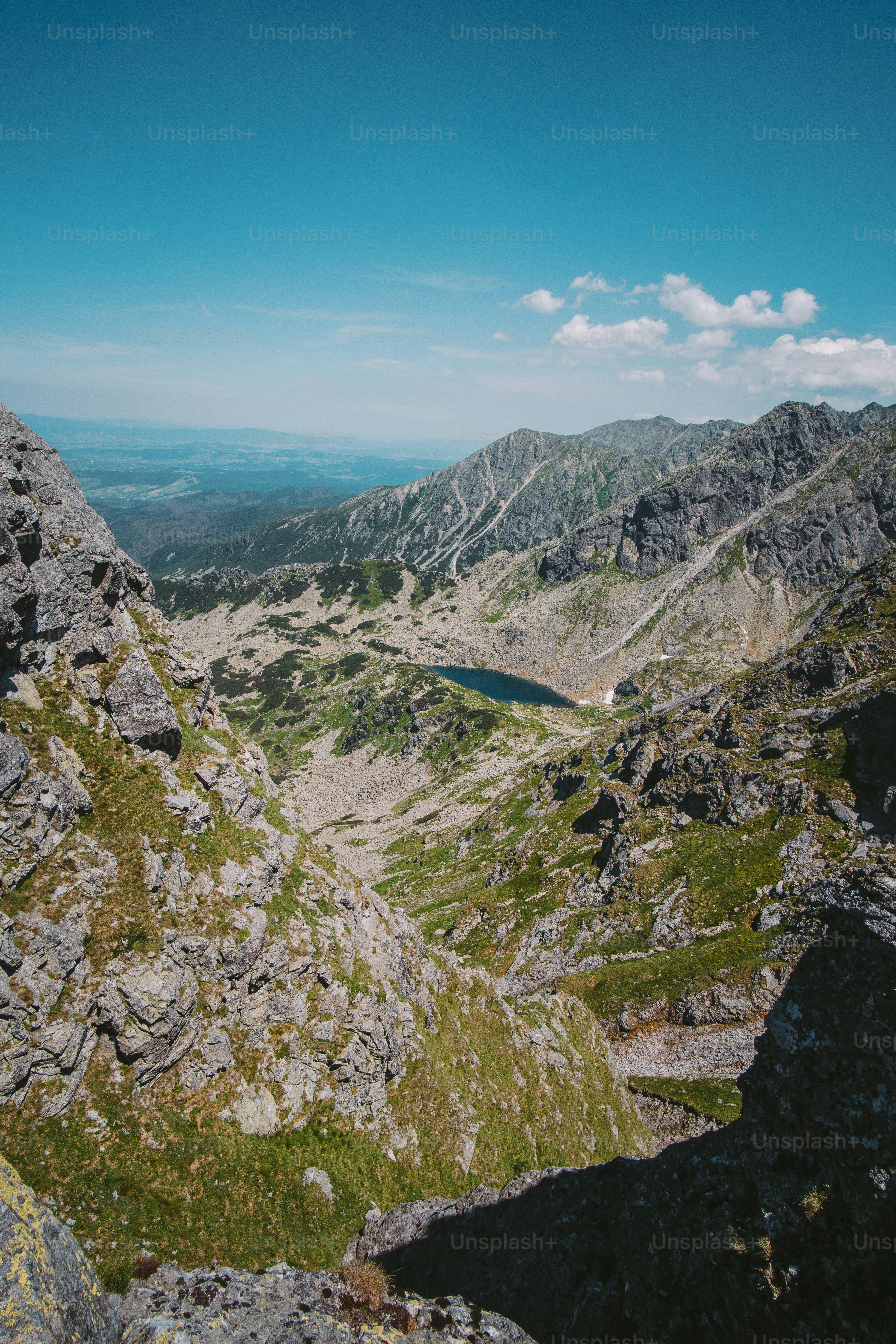 a view of a mountain range with a lake in the middle