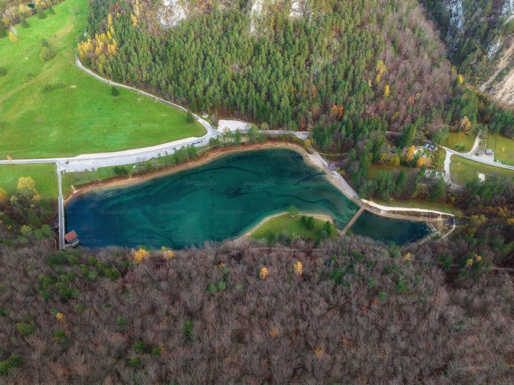 an aerial view of a lake surrounded by trees