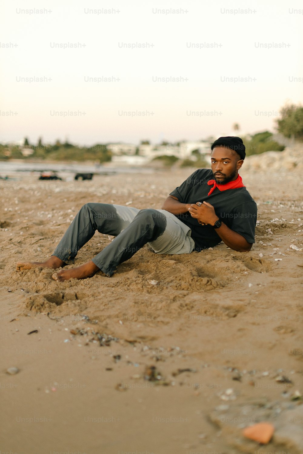 a man laying in the sand on a beach
