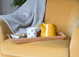 a tray with two mugs and a bowl on it