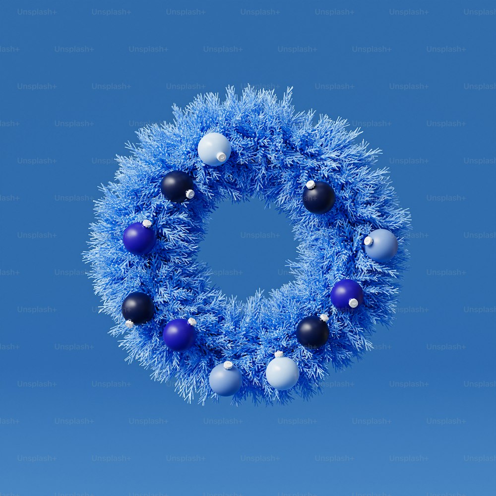 a blue christmas wreath with ornaments hanging from it