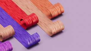 a group of different colored cords on a purple background