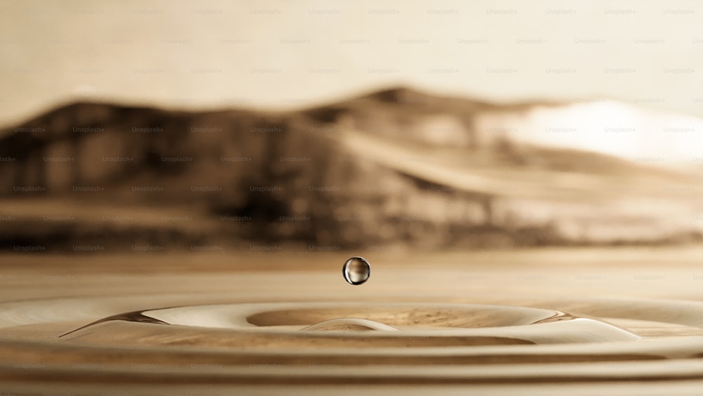 uma gota de água sentada em cima de uma mesa de madeira
