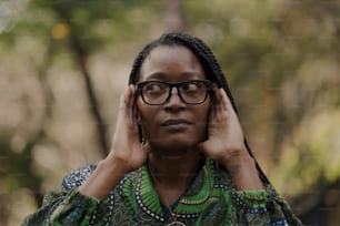 a woman wearing glasses and a green shirt