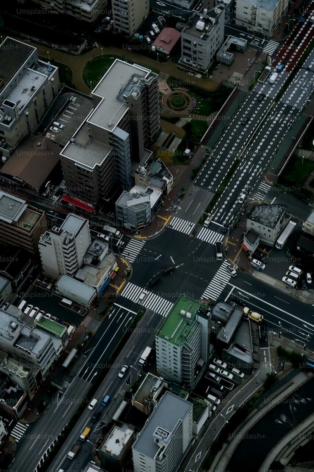 an aerial view of a city with a green roof