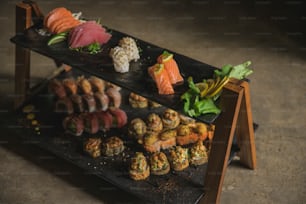 a display of sushi on a black tray