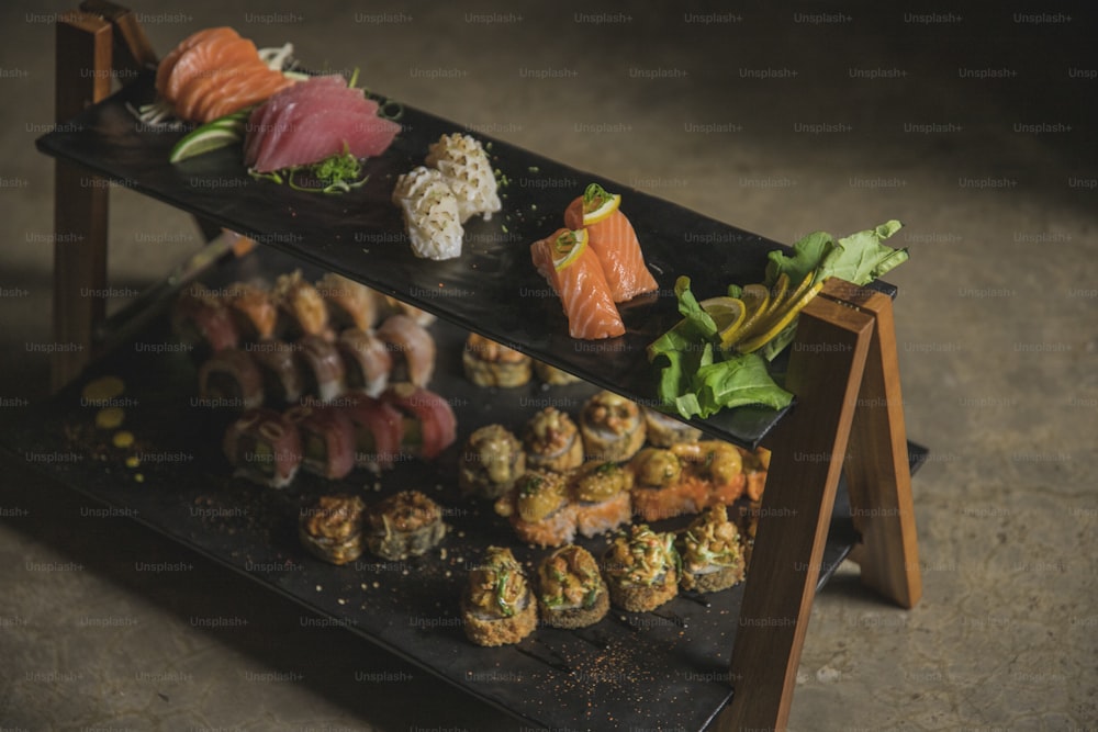 a display of sushi on a black tray