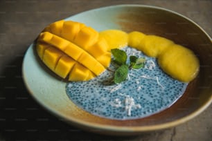 a bowl filled with blue and yellow fruit