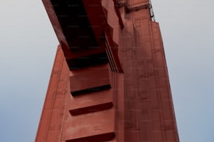 a tall red building with a clock on it's side