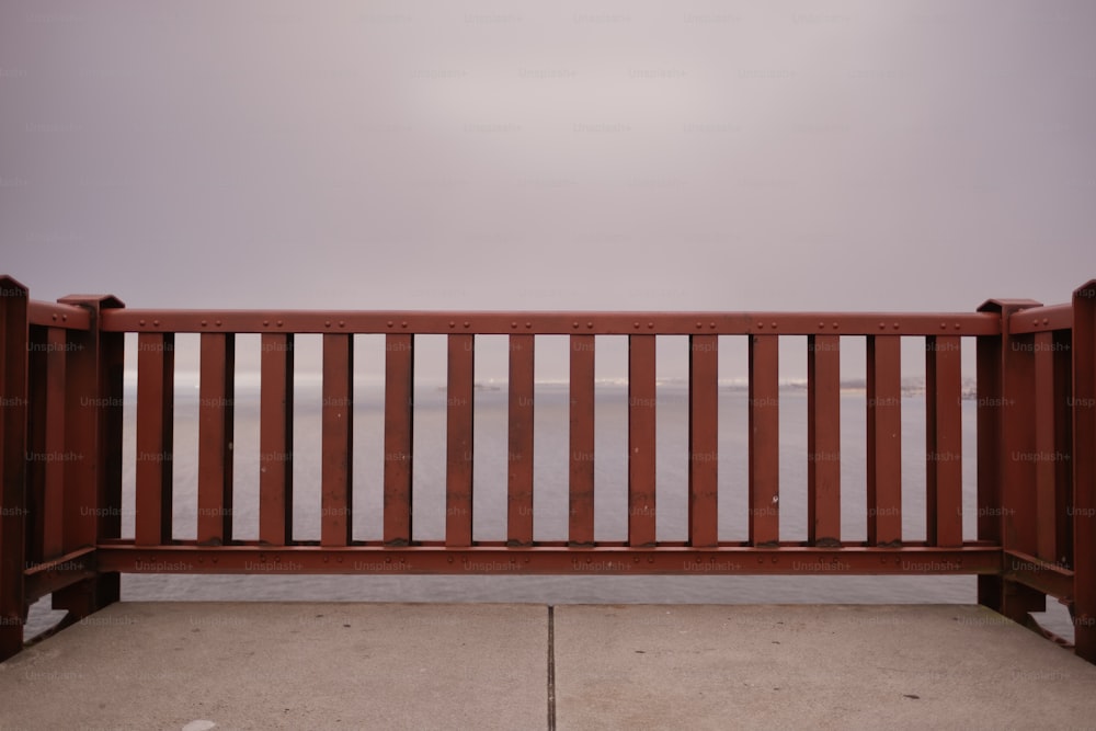 a wooden bench sitting on top of a cement floor