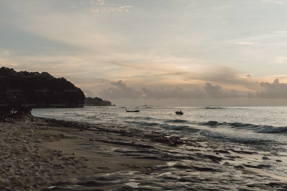 a beach with a boat in the water