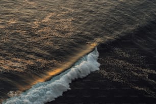 a large body of water with a wave coming in