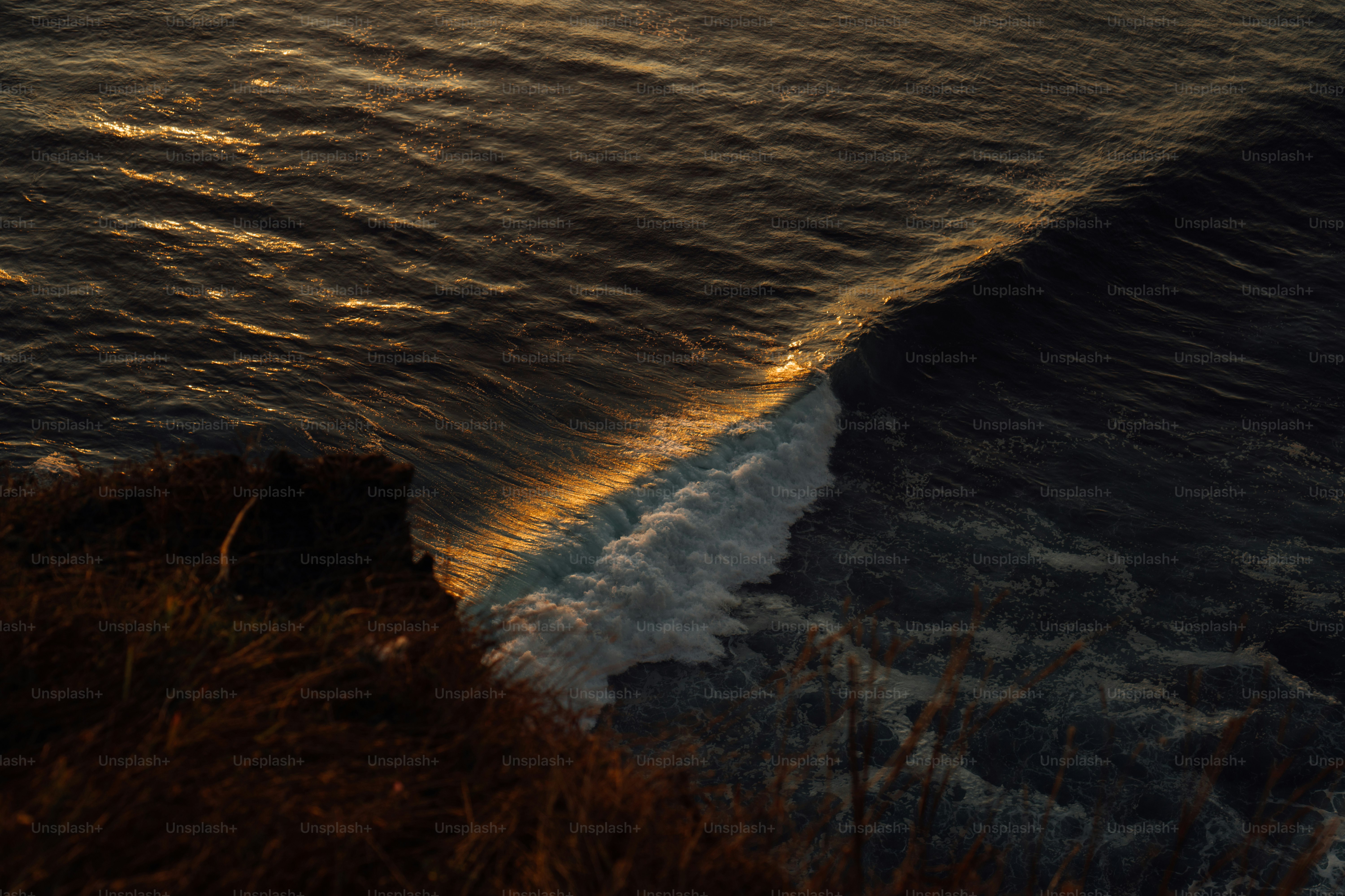 a body of water with waves coming in to shore