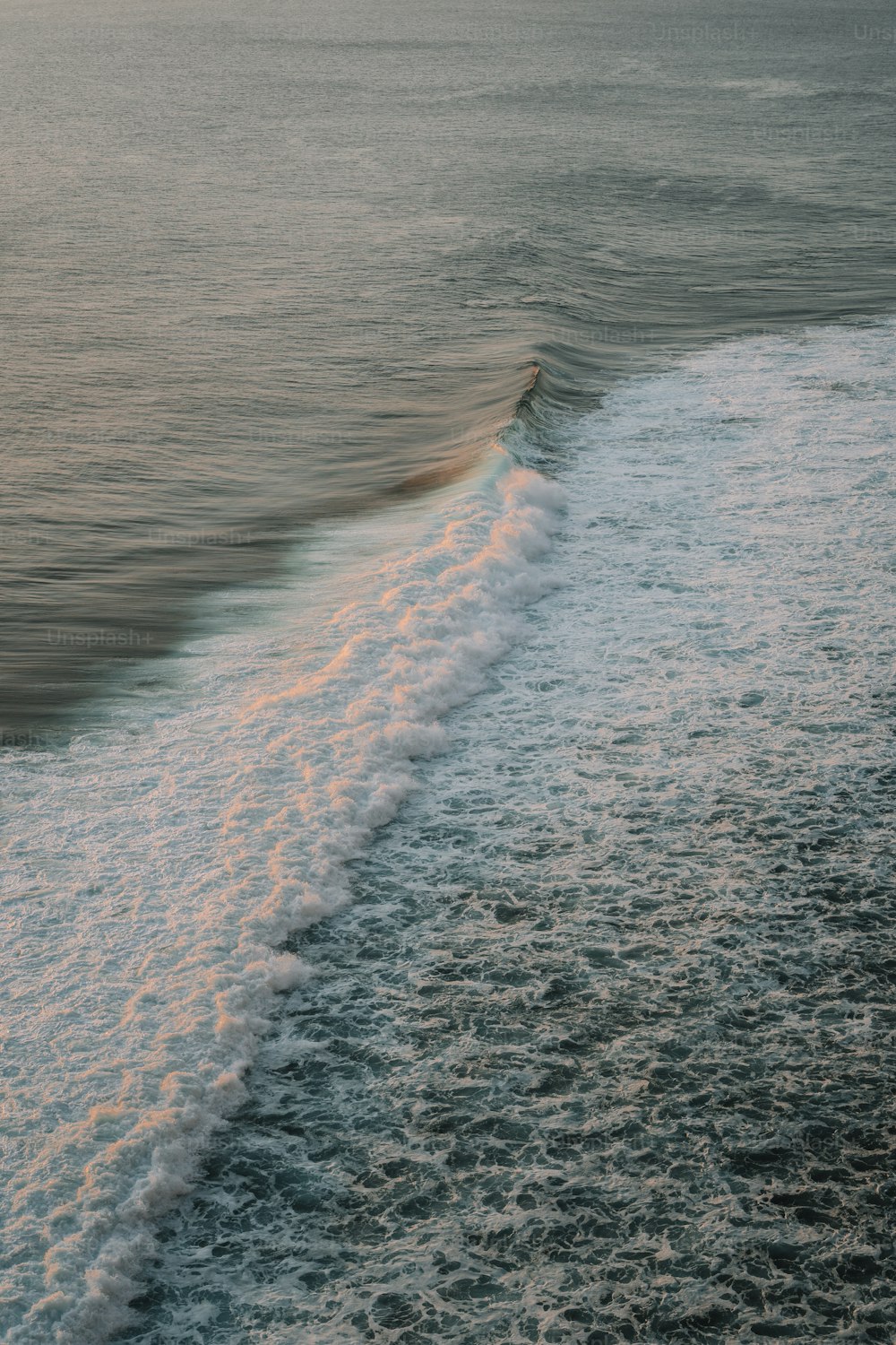 a person riding a surfboard on top of a wave