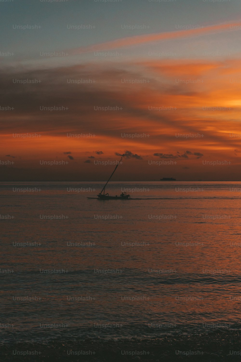 a boat is in the water at sunset