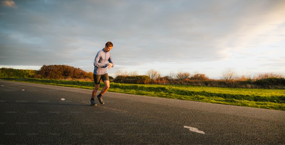 a man running down the road in the evening