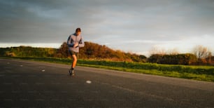 a man riding a skateboard down the middle of a road