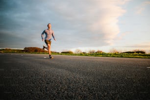 a man riding a skateboard down the middle of a road