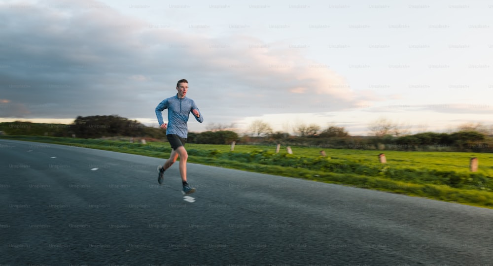 a man running down a road in the middle of the day